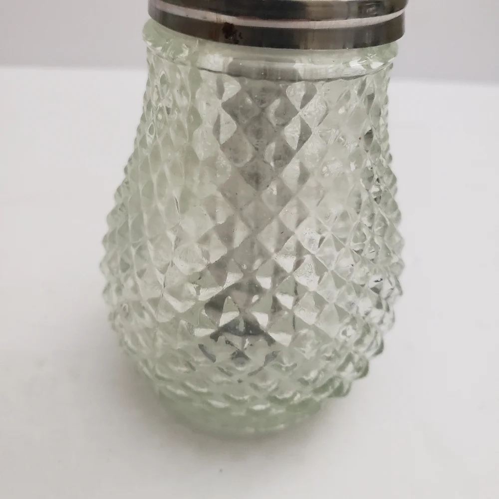 Glass sugar dispenser with a metal lid and spout. 206